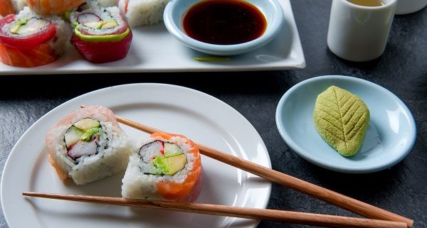 Authentic Japanese sushi meal with sushi roll, green tea, wasabi and soy sauce artistically arranged