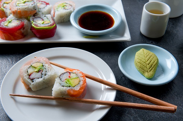 Authentic Japanese sushi meal with sushi roll, green tea, wasabi and soy sauce artistically arranged
