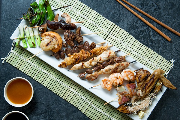 chicken yakitori and other skewered grilled delicacies from Osaka teppan yaki grill displayed on plate ready to eat