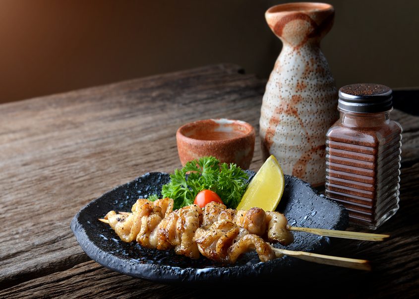 Chicken skin grilled with charcoal fire in Japanese style call torikawa or yakitori serve in izakaya food restaurant.