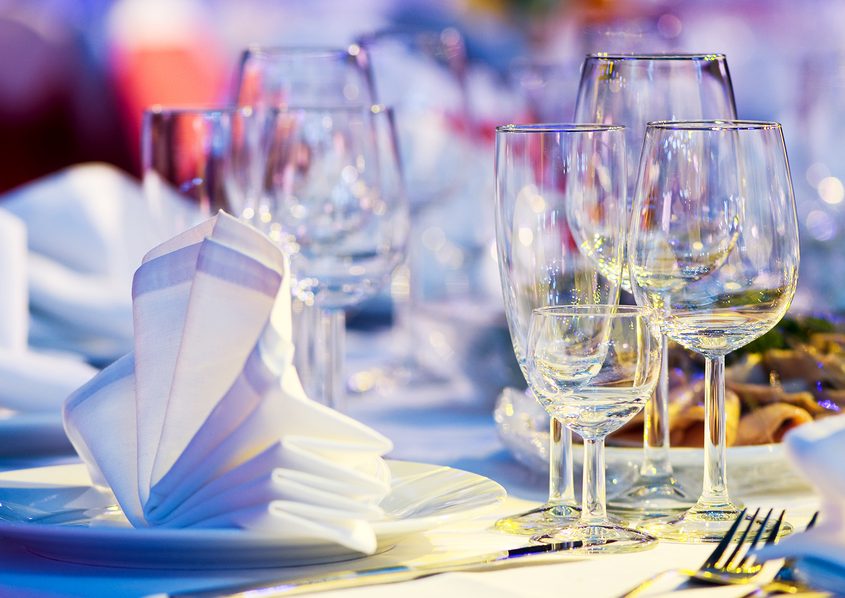 catering table set service with silverware, napkin and glass at restaurant