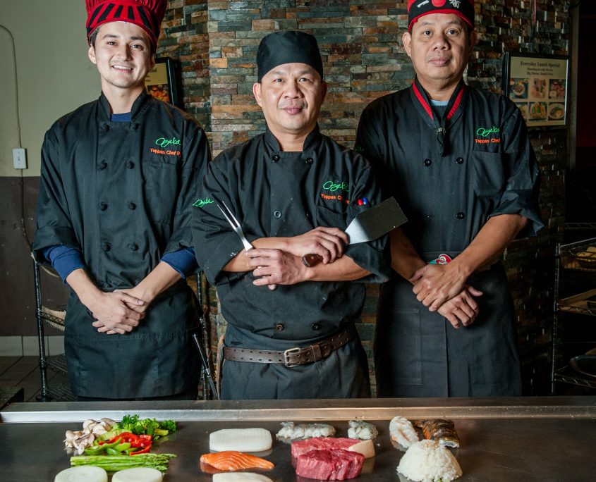 Osaka Japanese Bistro teppanyaki chefs at their grill portrait of three teppan expert chefs