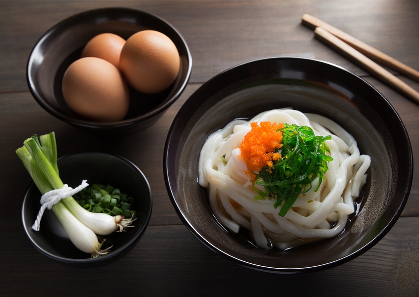 Udon Noodles in a soup base with scallions known as Kake udon or Su udon in Japanese cuisine